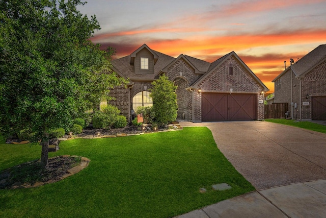4304 Caney Creek Cir, Celina, TX 75078 - view of front of home featuring concrete driveway, a yard, brick siding, and a garage