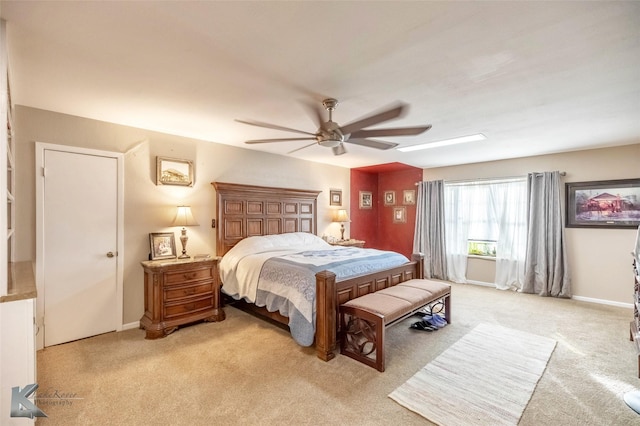 bedroom with light carpet, ceiling fan, and baseboards