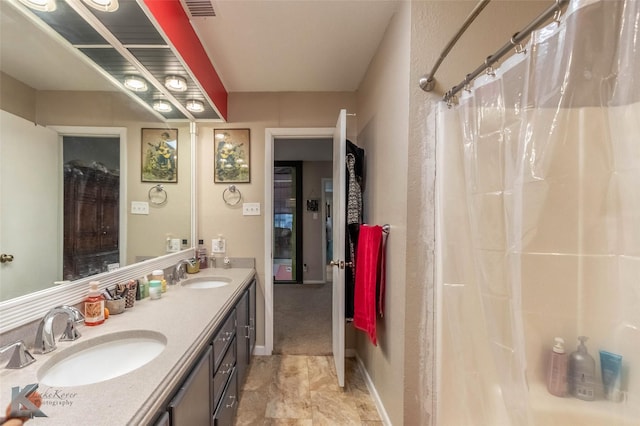 full bath with double vanity, visible vents, and a sink