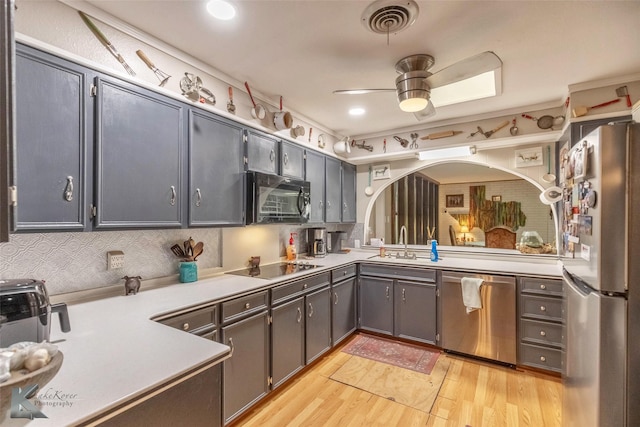 kitchen featuring ceiling fan, light wood-type flooring, visible vents, black appliances, and light countertops