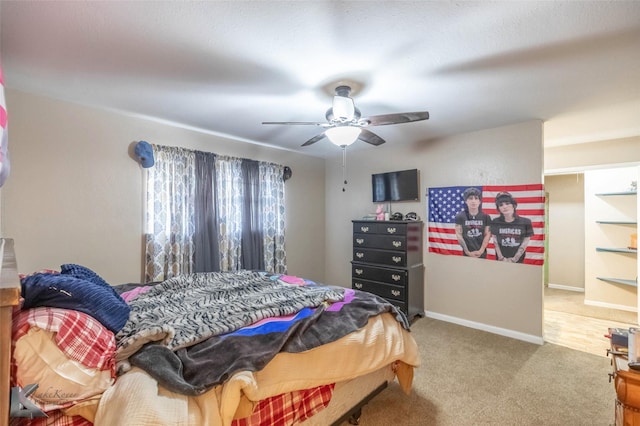 carpeted bedroom featuring ceiling fan and baseboards