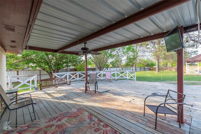 wooden terrace featuring a yard, a fenced backyard, and ceiling fan