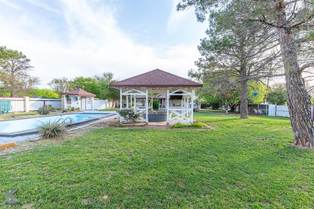 view of yard with a fenced backyard, a gazebo, an outdoor structure, and a fenced in pool