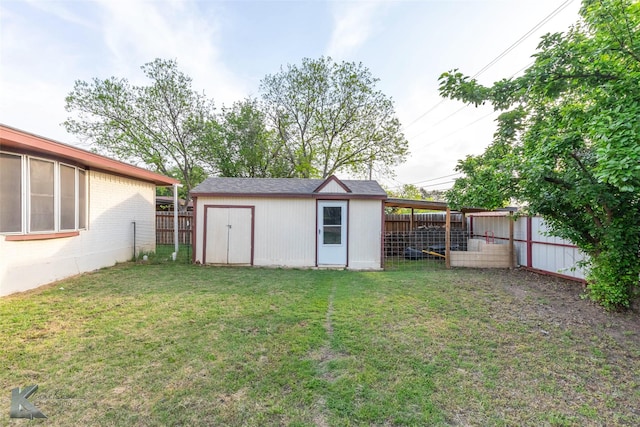 view of yard featuring a storage shed, a fenced backyard, and an outdoor structure