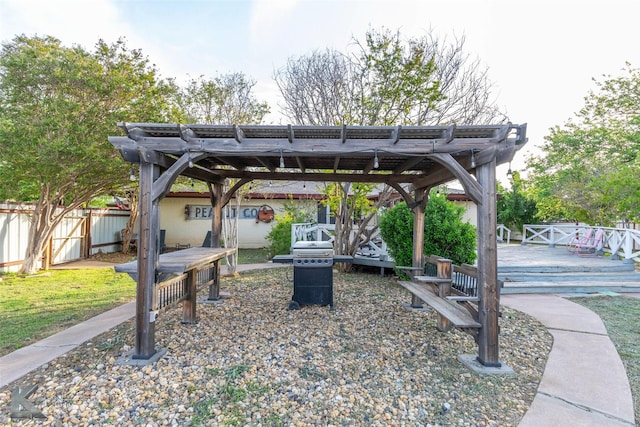 view of patio featuring fence, a deck, and a pergola