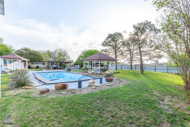 view of swimming pool featuring a gazebo, fence, and a lawn