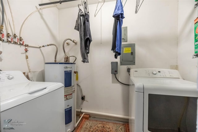 clothes washing area with water heater, baseboards, electric panel, washing machine and dryer, and laundry area
