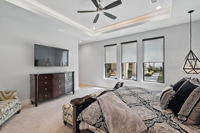 bedroom featuring a tray ceiling, baseboards, recessed lighting, and light colored carpet