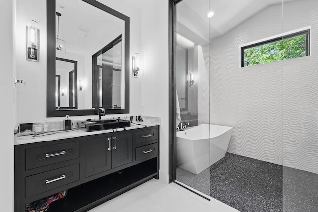 bathroom with a freestanding tub and vanity