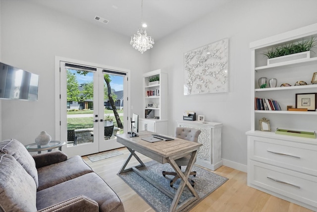 office space featuring a chandelier, french doors, visible vents, and light wood-style flooring