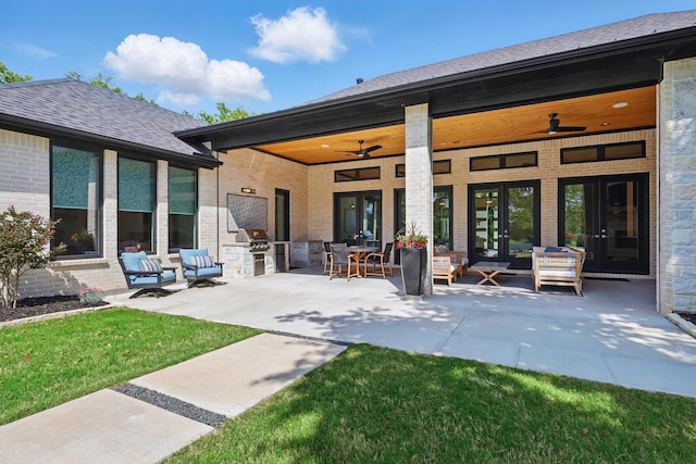 back of house with a patio, brick siding, french doors, and an outdoor kitchen