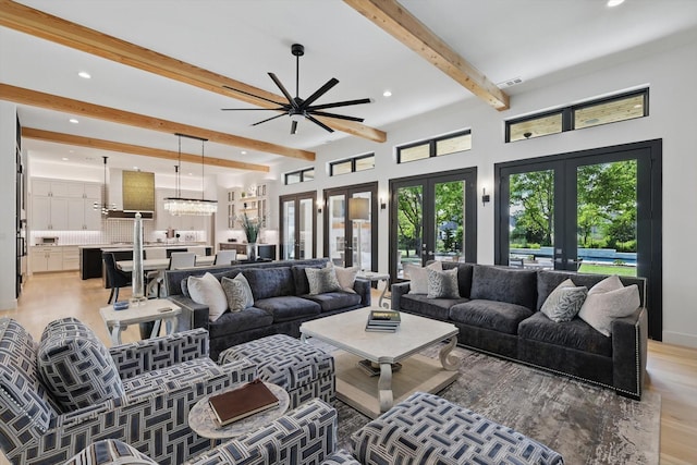 living room with light wood-type flooring, recessed lighting, french doors, beamed ceiling, and ceiling fan