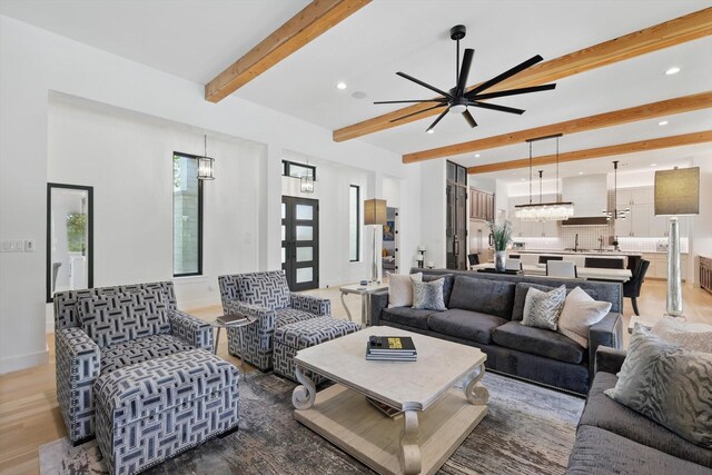 living area featuring light wood-style floors, ceiling fan, recessed lighting, baseboards, and beam ceiling