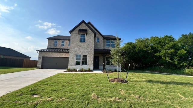 213 Pilot Dr, Caddo Mills, TX 75135 - view of front of property featuring concrete driveway, a garage, a standing seam roof, and a porch