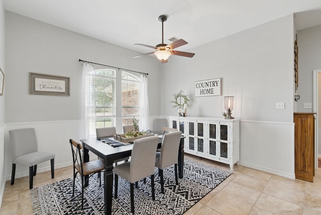 202 Hill Valley Dr, Stephenville, TX 76401 - tiled dining area with a ceiling fan, wainscoting, and visible vents