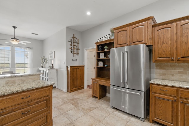 202 Hill Valley Dr, Stephenville, TX 76401 - kitchen with tasteful backsplash, open shelves, brown cabinets, ceiling fan, and high quality fridge