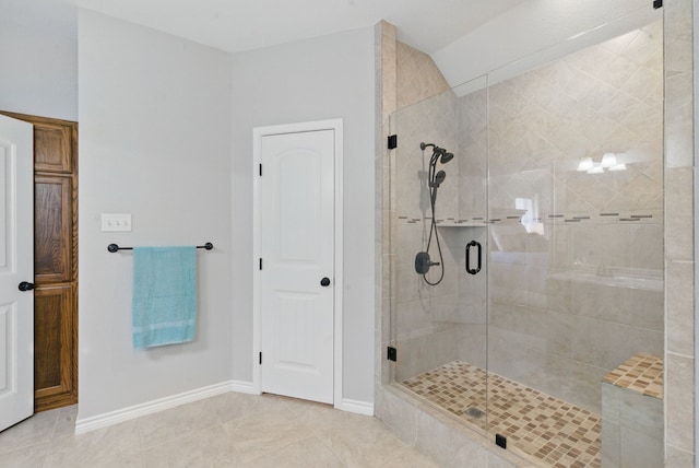 202 Hill Valley Dr, Stephenville, TX 76401 - bathroom with tile patterned floors, baseboards, a shower stall, and vaulted ceiling
