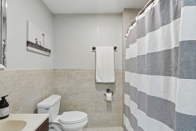 202 Hill Valley Dr, Stephenville, TX 76401 - full bath with vanity, toilet, a heating unit, wainscoting, and tile walls
