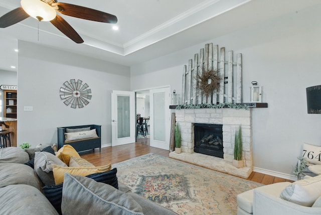 202 Hill Valley Dr, Stephenville, TX 76401 - living area with baseboards, a stone fireplace, a ceiling fan, crown molding, and wood finished floors