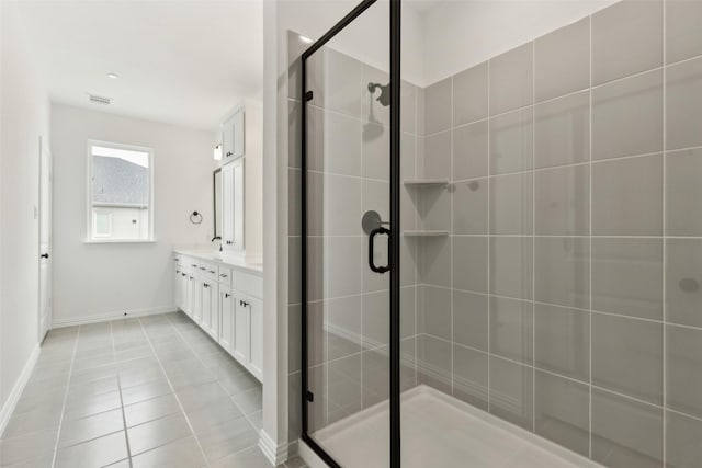 15712 Millwood Trl, Frisco, TX 75033 - full bathroom with a stall shower, double vanity, baseboards, tile patterned flooring, and visible vents