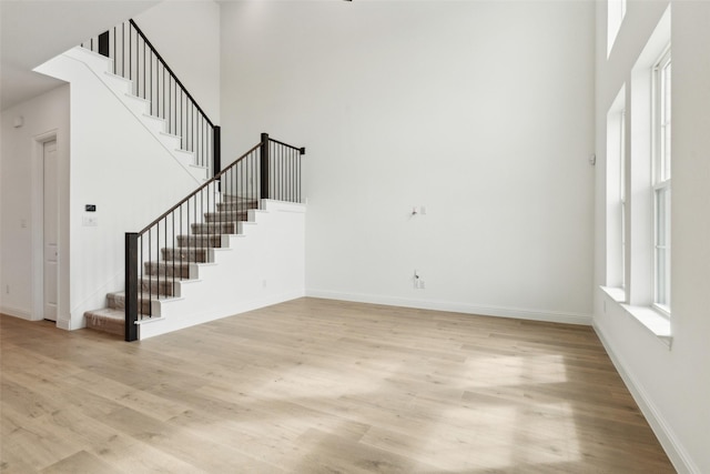15712 Millwood Trl, Frisco, TX 75033 - unfurnished living room with light wood-style floors, baseboards, and stairs