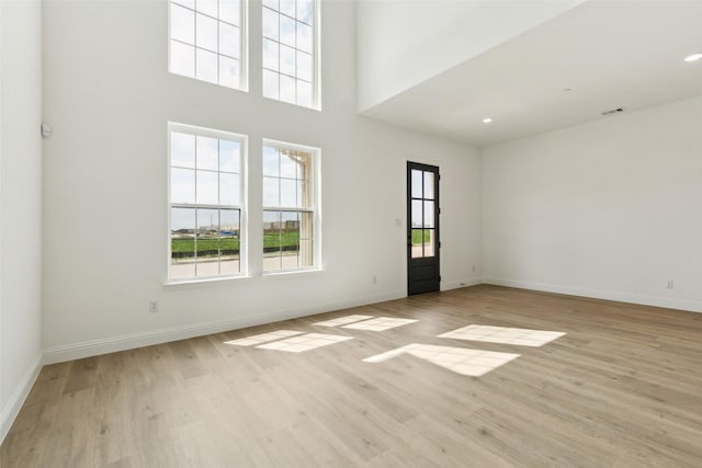 15712 Millwood Trl, Frisco, TX 75033 - spare room with a healthy amount of sunlight, light wood finished floors, and baseboards