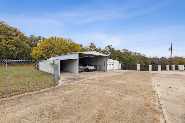7342 Briar Rd, Azle, TX 76020 - view of outbuilding featuring a detached carport, driveway, fence, and an outdoor structure