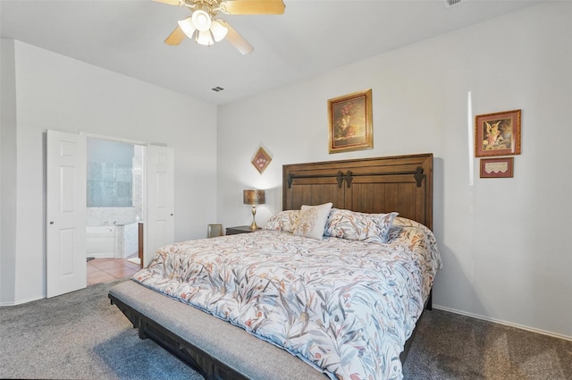 carpeted bedroom featuring ensuite bathroom, baseboards, a ceiling fan, and visible vents
