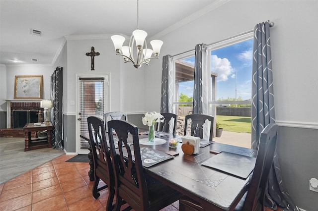 tiled dining space featuring a chandelier, crown molding, visible vents, and plenty of natural light