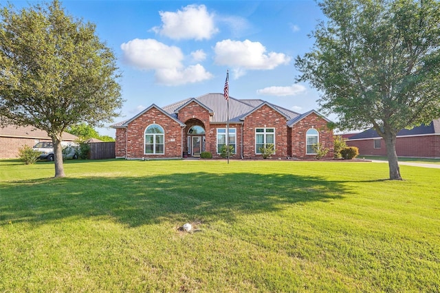 view of front of property featuring a front lawn and brick siding