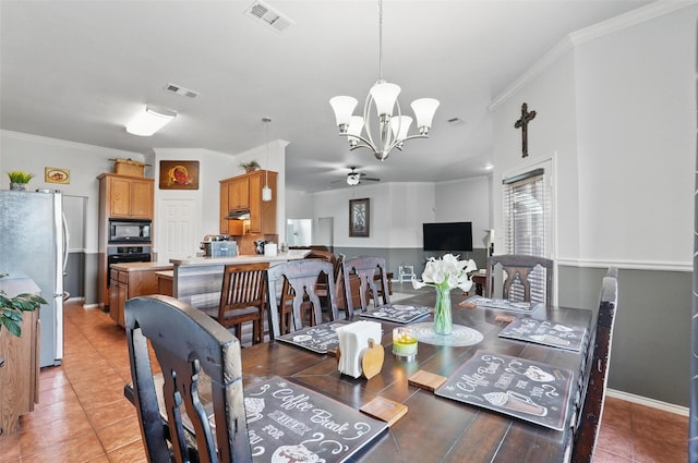 dining space with light tile patterned floors, visible vents, ceiling fan with notable chandelier, and crown molding