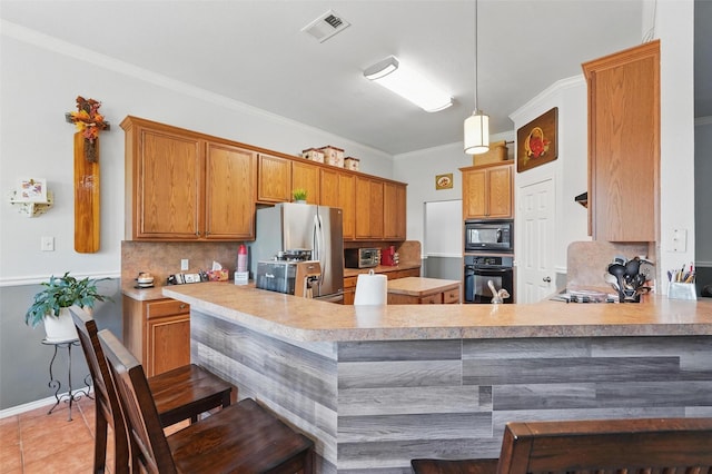 kitchen featuring tasteful backsplash, visible vents, light countertops, and black appliances