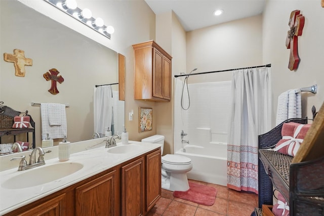 bathroom featuring toilet, shower / bath combo with shower curtain, a sink, and tile patterned flooring