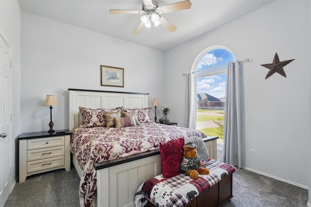 bedroom with baseboards, a ceiling fan, and dark colored carpet