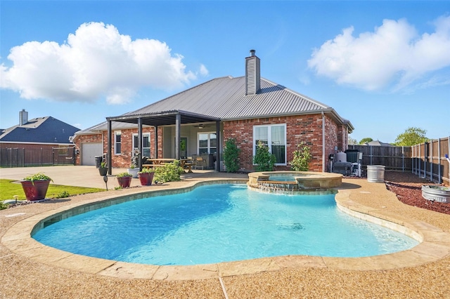 view of swimming pool featuring a patio area, a pool with connected hot tub, and fence
