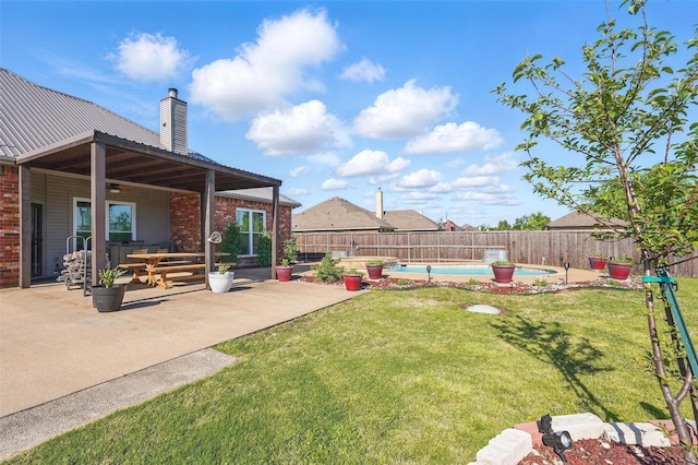 view of yard featuring a fenced backyard, a fenced in pool, and a patio