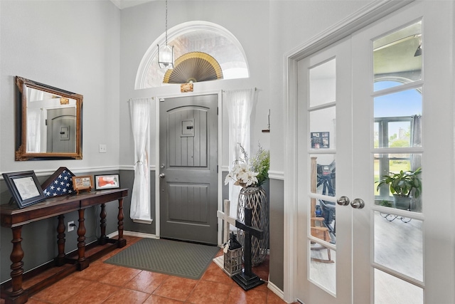 foyer entrance with french doors and tile patterned flooring