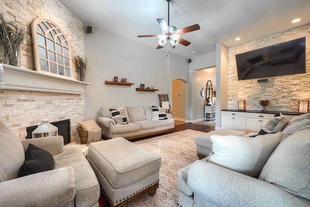 3419 Willowcreek Dr, Sunnyvale, TX 75182 - living area featuring ceiling fan, arched walkways, recessed lighting, wood finished floors, and a stone fireplace