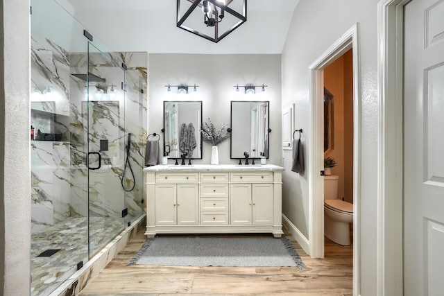 3419 Willowcreek Dr, Sunnyvale, TX 75182 - bathroom with double vanity, wood finished floors, toilet, and a marble finish shower