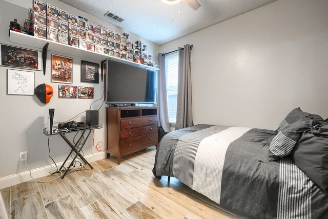 3419 Willowcreek Dr, Sunnyvale, TX 75182 - bedroom featuring baseboards, visible vents, wood finished floors, and a textured ceiling