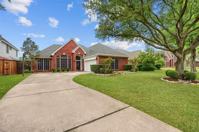 3419 Willowcreek Dr, Sunnyvale, TX 75182 - view of front of home featuring brick siding, a garage, driveway, and roof with shingles