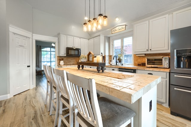 3419 Willowcreek Dr, Sunnyvale, TX 75182 - kitchen featuring a toaster, black appliances, light countertops, and plenty of natural light