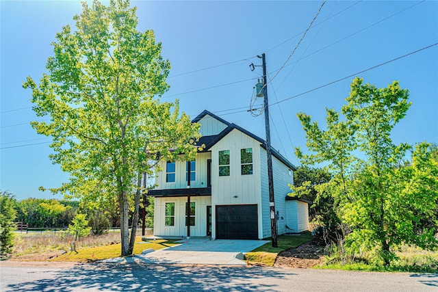 view of front facade featuring board and batten siding, a garage, and concrete driveway
