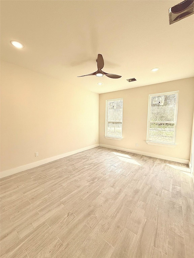 unfurnished room featuring ceiling fan, light wood-style flooring, visible vents, recessed lighting, and baseboards