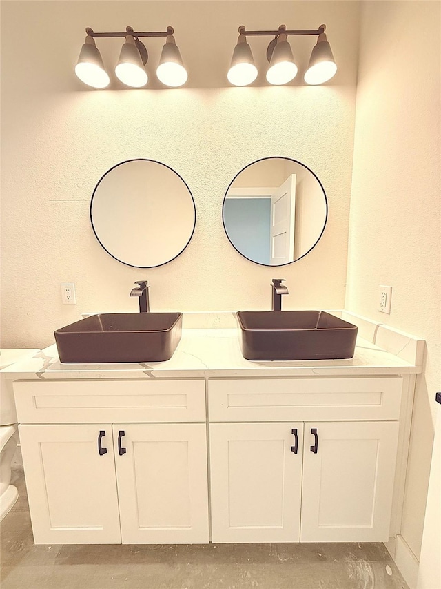 full bathroom with double vanity and a sink