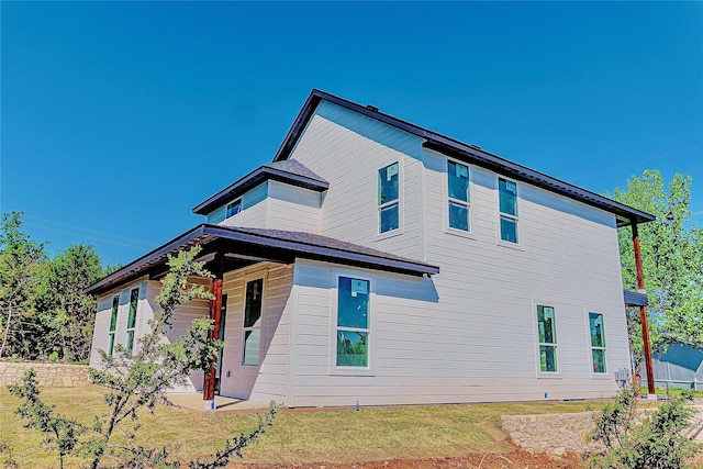 view of side of property with a lawn