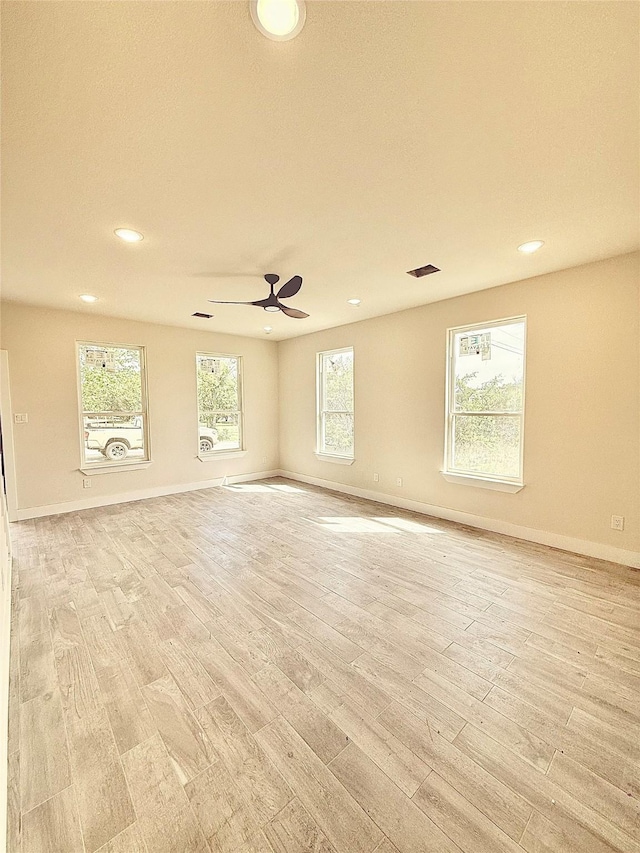 empty room with recessed lighting, light wood finished floors, baseboards, and a ceiling fan