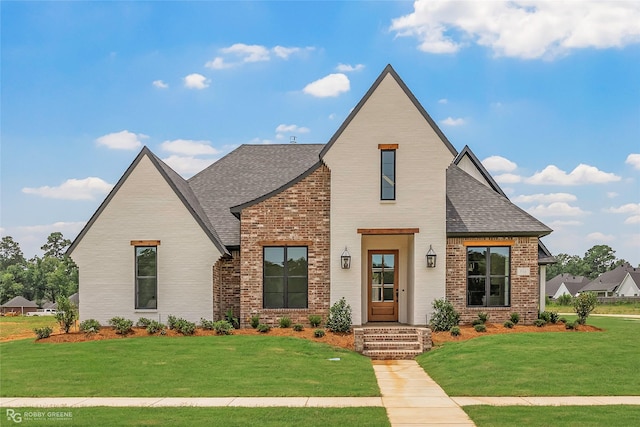 916 Aaron Ln, Benton, LA 71006 - view of front of house with brick siding, roof with shingles, and a front lawn