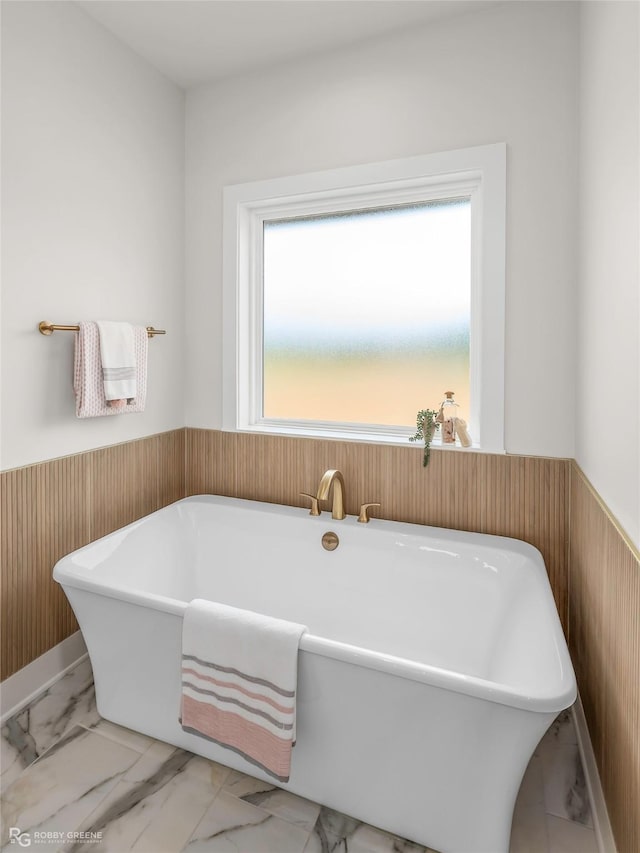 916 Aaron Ln, Benton, LA 71006 - full bath with a wainscoted wall, marble finish floors, a soaking tub, and wooden walls