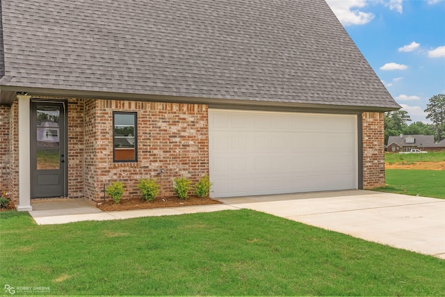 916 Aaron Ln, Benton, LA 71006 - view of front of house featuring roof with shingles, concrete driveway, brick siding, a front yard, and an attached garage